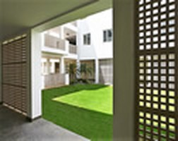 Landscaped courtyard at Asia Bhawan, seen through a perforated screen wall