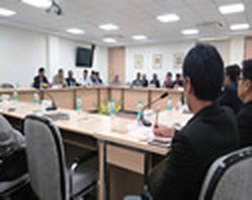 Delegates seated around the conference table during a session at Asia Bhawan