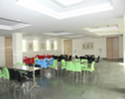 Naturally lit hall with tables and stacking chairs